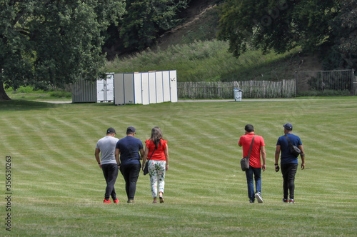 people walking in the green grass 