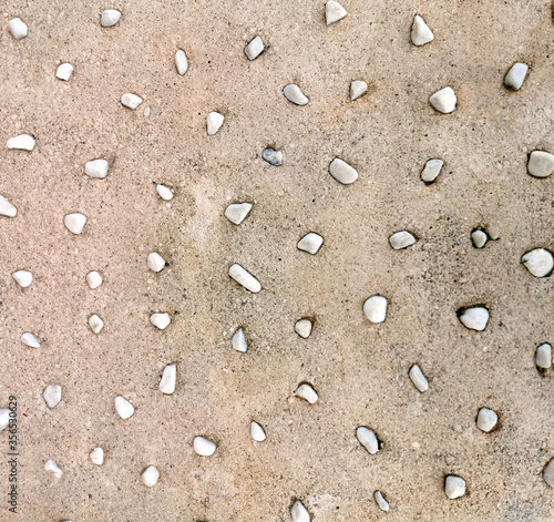 texture of stones sticking out of their concrete pouring