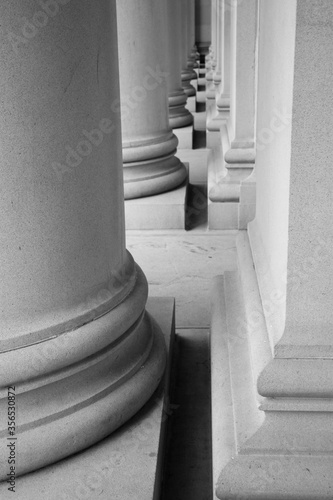 Abstract, black and white, fine art photography of stone landmark building exteriors including windows, columns, roof architecture and decorative features.