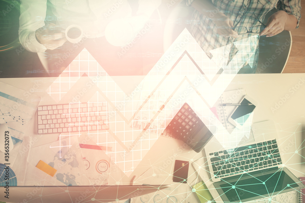 Fototapeta premium Double exposure of man and woman working together and arrows drawing. Computer background. Top View. Growth concept.