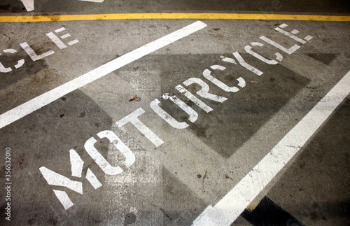 Abstract shots of parking lot with white and yellow stripes, arrows, signs, and symbols