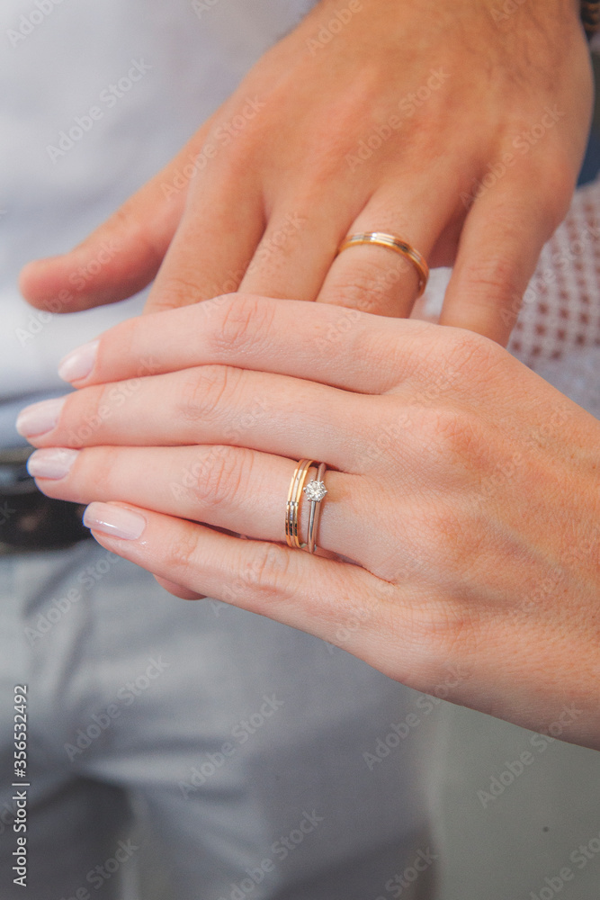 white hands with wedding rings