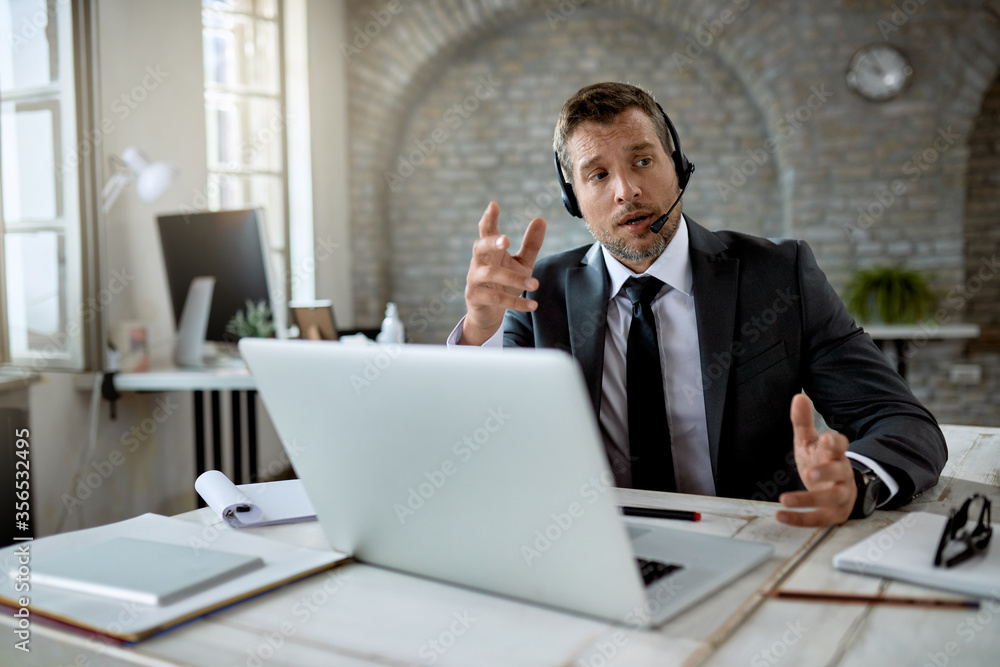 Businessman using laptop for online meeting while working in the office. Businessman using laptop for online meeting while working in the office.