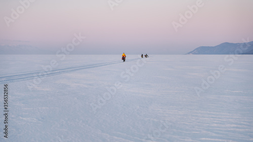 Byciclists on Baikal Lake in winter