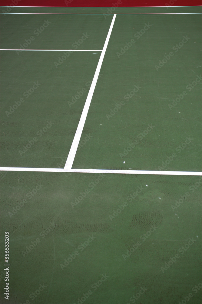 Various angles of green tennis courts with white stripes and nets