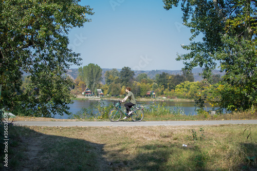 woman riding bicycle by the lake 