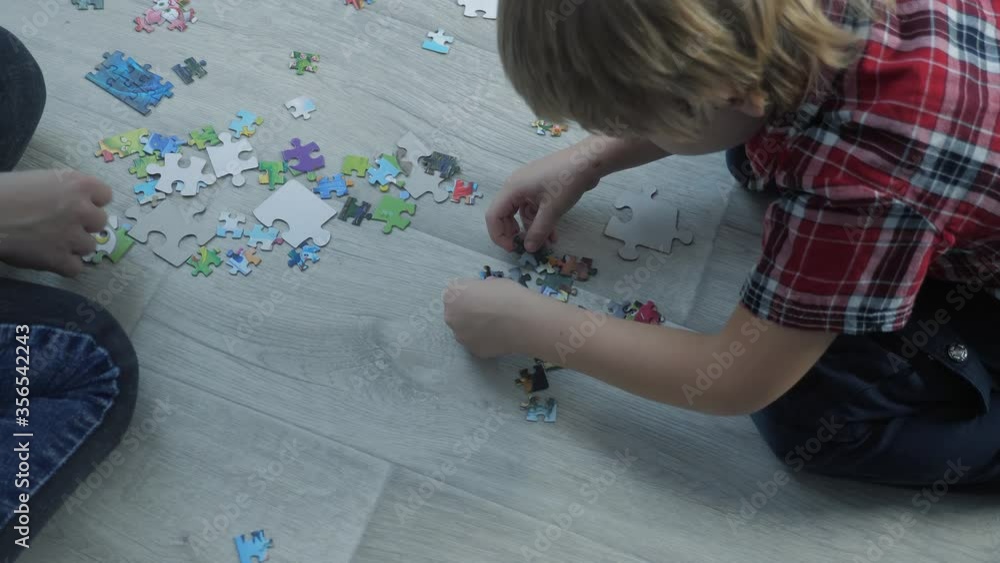 happy family collection puzzles teamwork. development of fine motor skills and thinking lifestyle . little a son boy and girl mom collect mosaic puzzles happy family collection puzzles teamwork. development of fine motor skills and thinking lifestyle . little a son boy and girl mom collect mosaic puzzles
