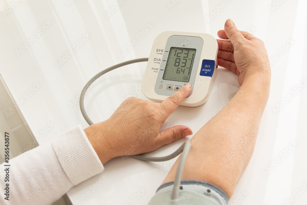 woman checks blood pressure at home and it is normal woman checks blood pressure at home and it is normal