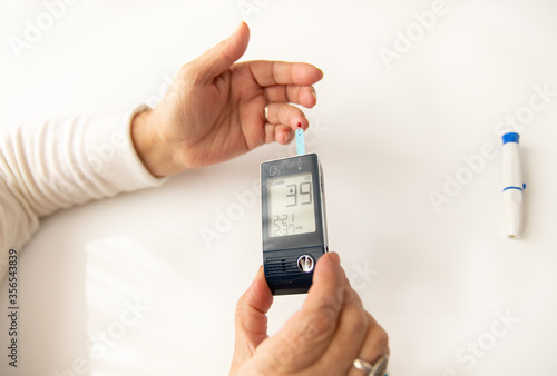 Woman Hands Testing Her Blood Sugar level With Glucometer