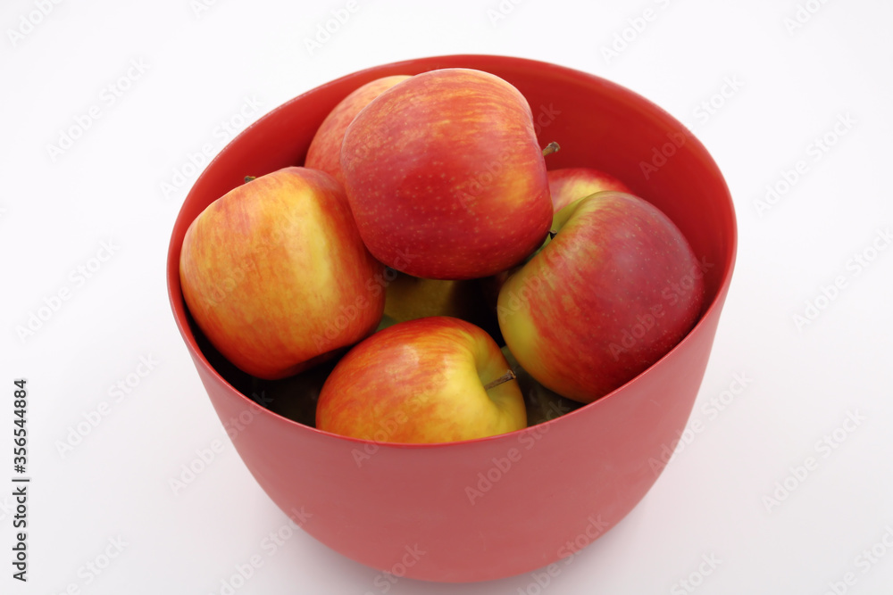 Red apples in red glass fruit bowl, isolated. Red apples in red glass fruit bowl, isolated.
