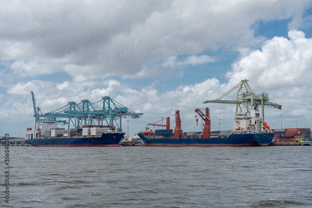 Cargo ships at port to load and unload containers. Cargo ships at port to load and unload containers.