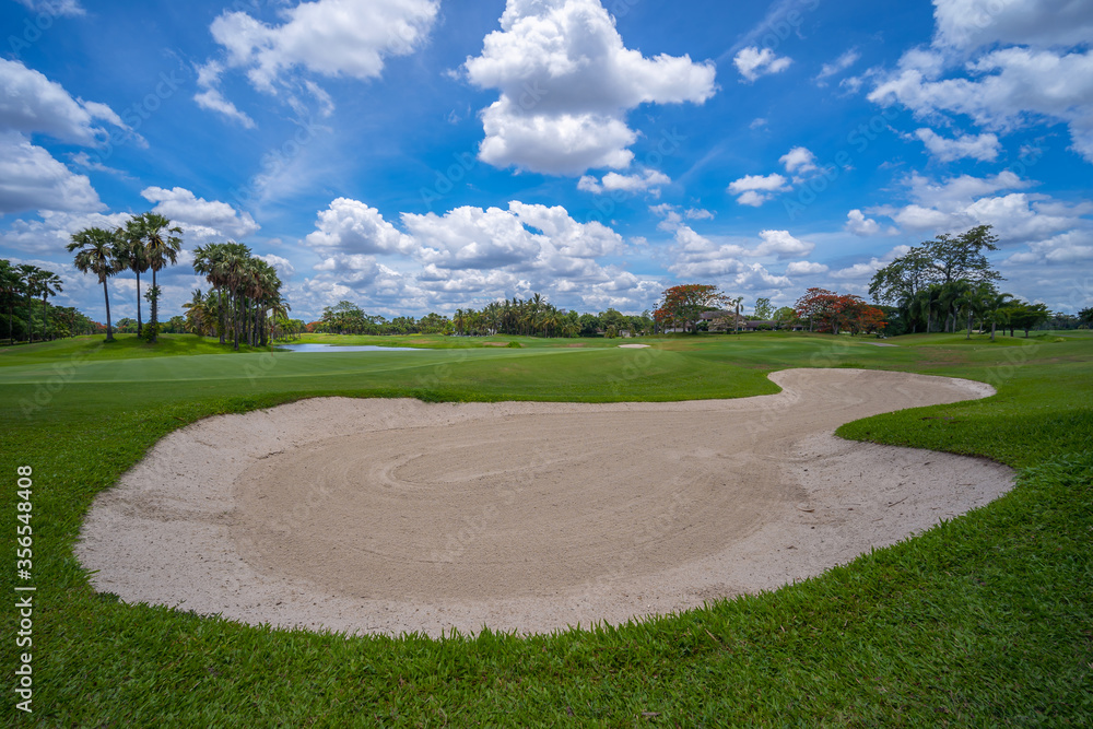 Green golf course with white cloud and blue sky Green golf course with white cloud and blue sky
