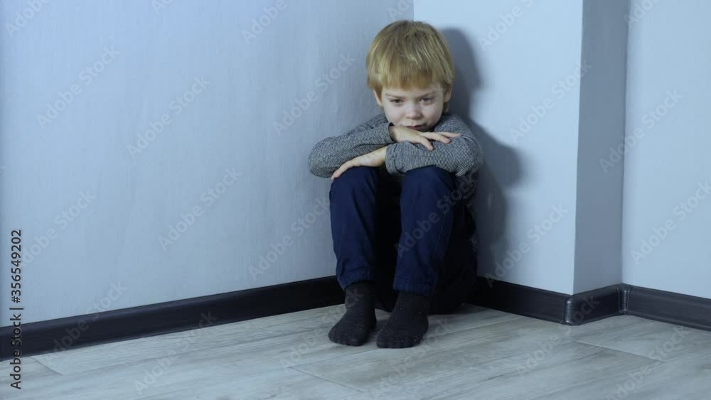 Domestic violence concept. sad upset boy sitting lifestyle in corner. Child punished sitting crying in the corner. Child abuse Domestic violence concept. sad upset boy sitting lifestyle in corner. Child punished sitting crying in the corner. Child abuse