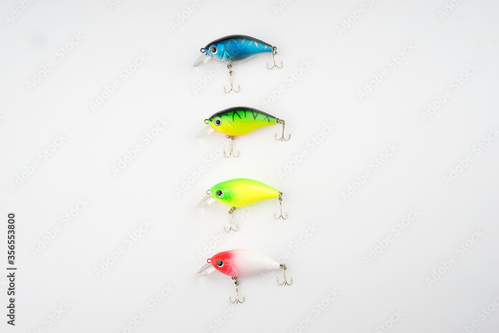Obraz premium Creative arrangements of wobbler lures. Fishing lure with hooks. Plastic fish with hooks. Flat lay or top view.