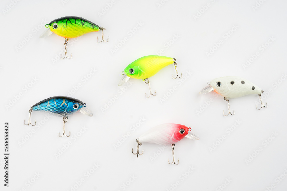 Creative arrangements of wobbler lures. Fishing lure with hooks. Plastic fish with hooks. Flat lay or top view. Creative arrangements of wobbler lures. Fishing lure with hooks. Plastic fish with hooks. Flat lay or top view.