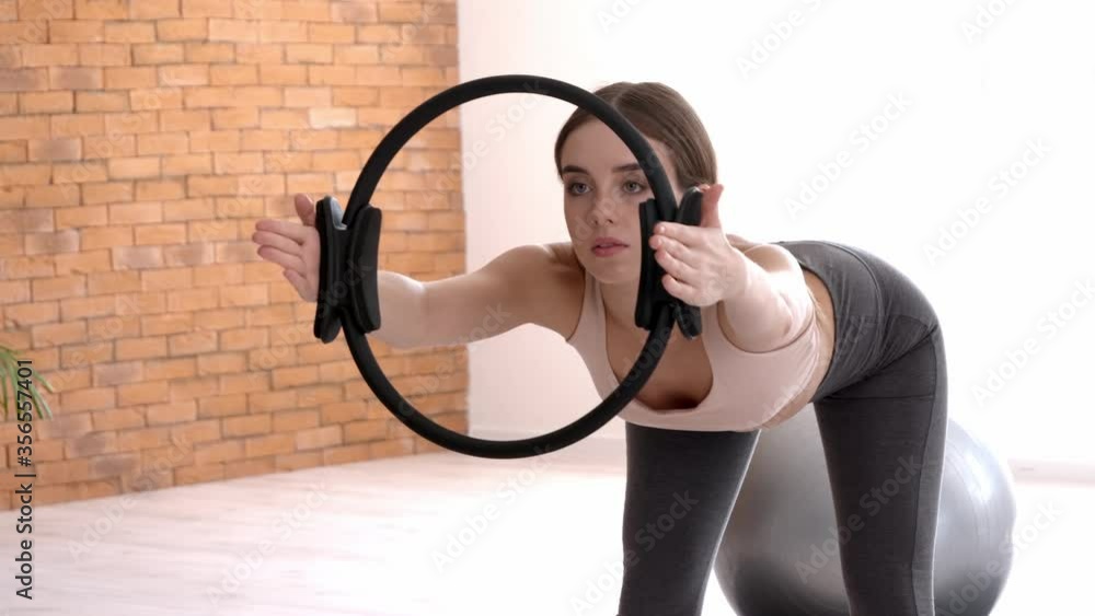 Sporty young woman training with isotonic ring at home Sporty young woman training with isotonic ring at home