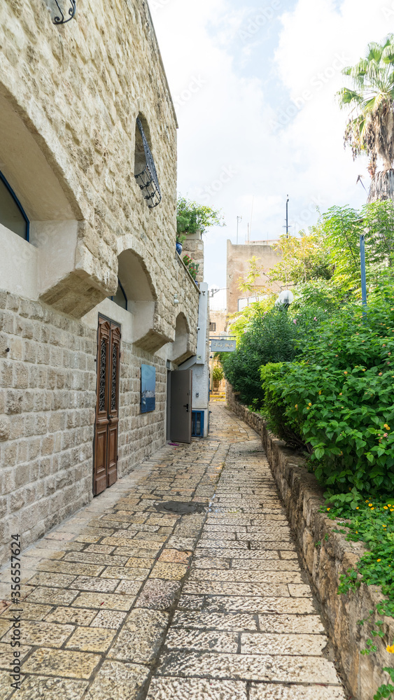 Jerusalem stone house on narrow street of Old Yafo (Jaffa). Tel Aviv, Israel.