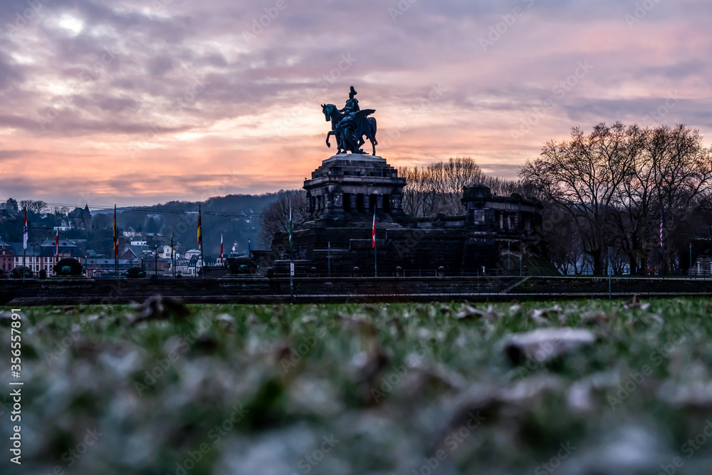 Fototapeta premium Colorful Sunrise burning sky Koblenz City historic monument German Corner where river rhine and mosele flow together