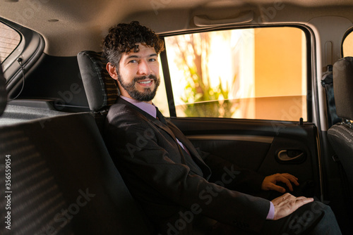 Businessperson using a car service. © Julio Ricco