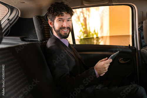 Business man smiling at the camera in car service. © Julio Ricco