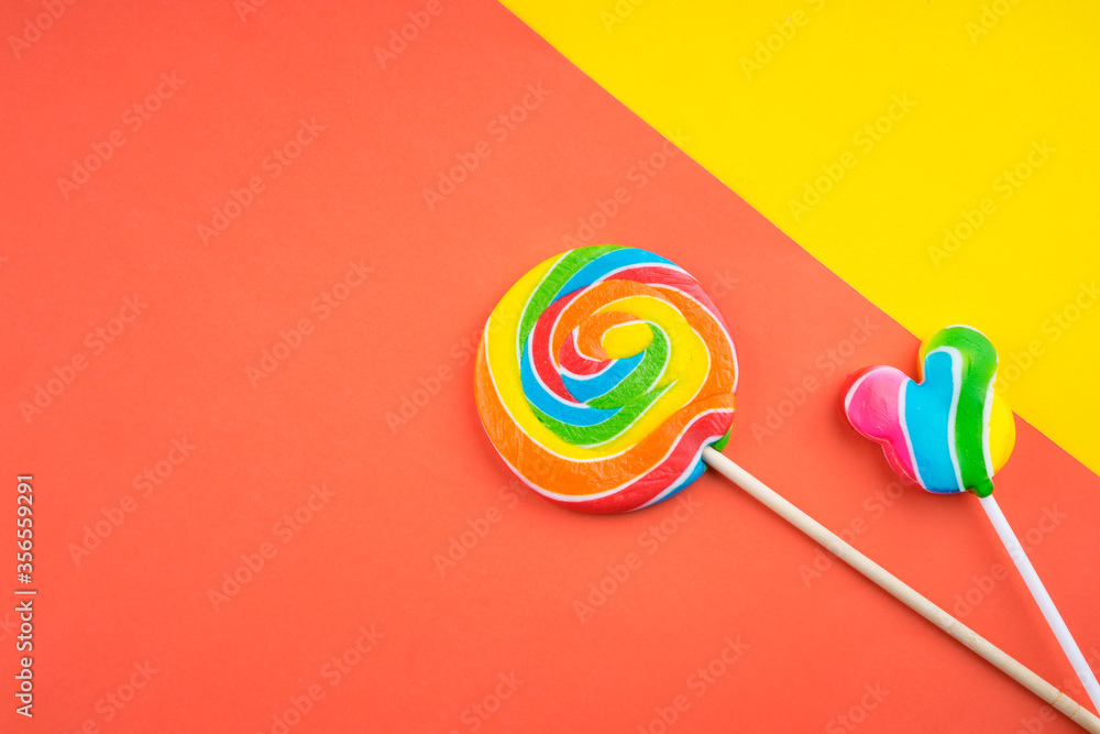 Candies and Sweets concept. Colorful lollipops on vibrant colored background Candies and Sweets concept. Colorful lollipops on vibrant colored background