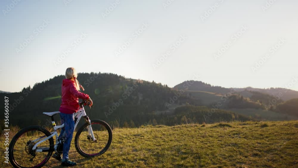 Active senior woman with e-bike cycling outdoors in nature. Active senior woman with e-bike cycling outdoors in nature.