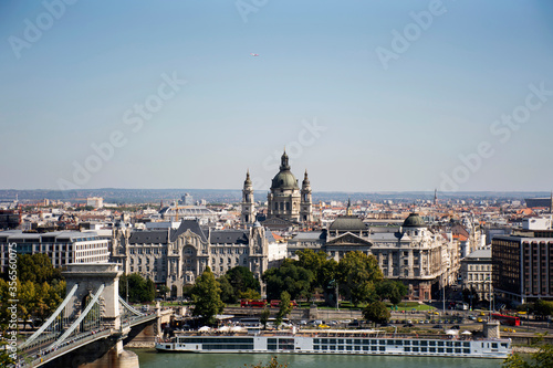 View landscape and cityscape of Budapest old town city and Hungarian Parliament with tour cruises in Danube Delta river and Budapest Chain Bridge in Budapest, Hungary © tuayai