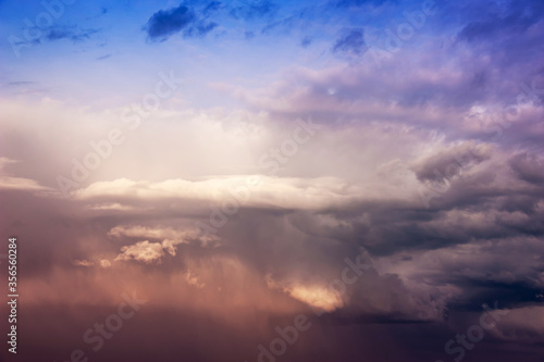 Natural sky composition. Dark ominous colorful storm rain clouds. Dramatic sky. Overcast stormy cloudscape. Thunderstorm. Element of apocalypse design. Toned.