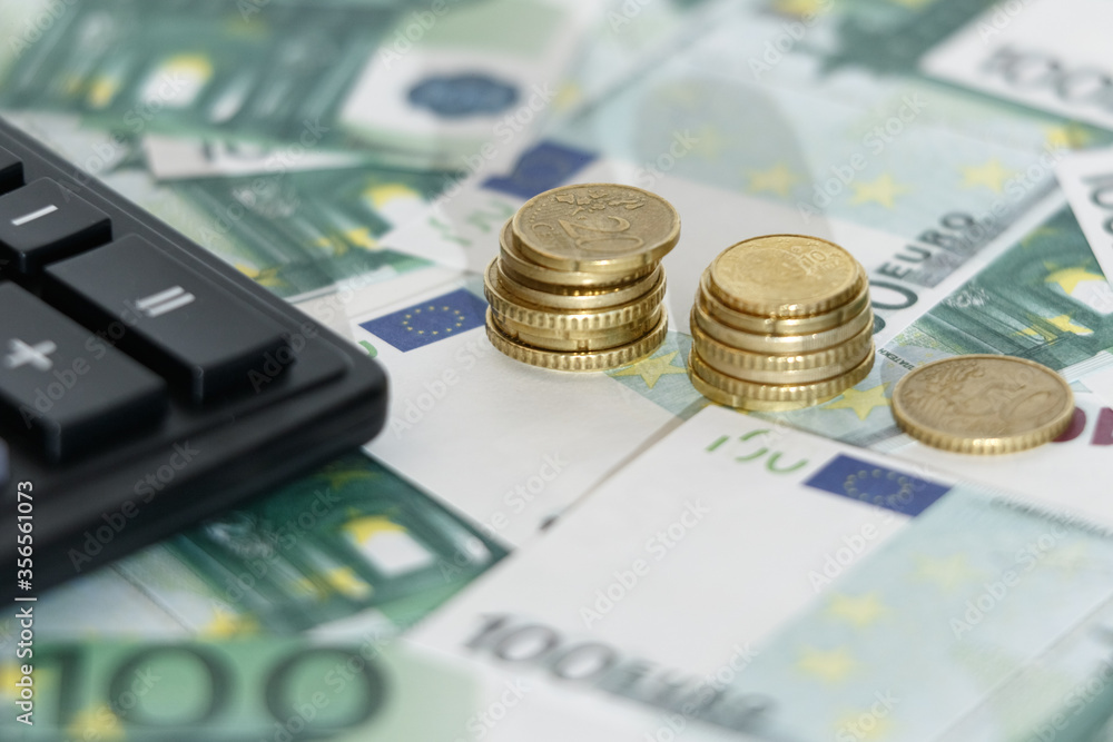 Euro banknotes with a calculator and coins. Business concept Euro banknotes with a calculator and coins. Business concept