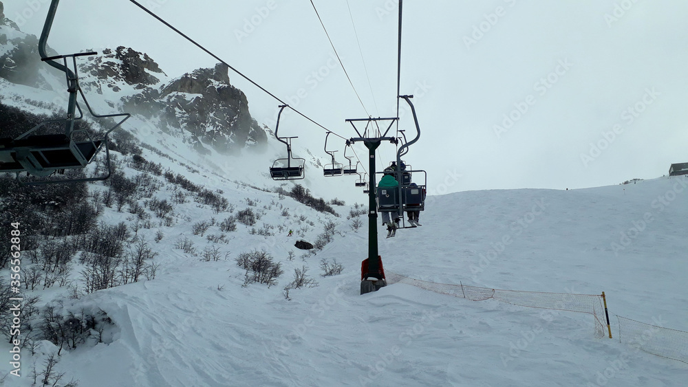 skiers on ski lift