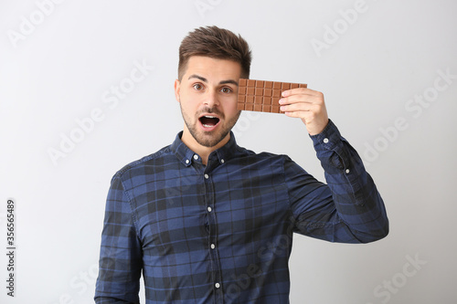 Surprised young man with ta...