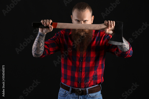 Handsome lumberjack on dark background