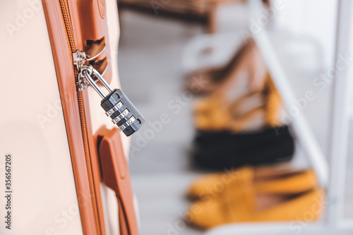 Suitcase with lock in hall, closeup