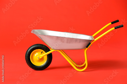 Valokuva Empty wheelbarrow on color background
