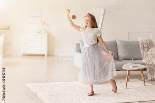 Cute redhead girl dancing at home