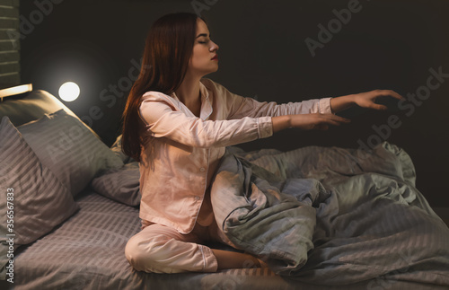 Female sleepwalker in bedro...
