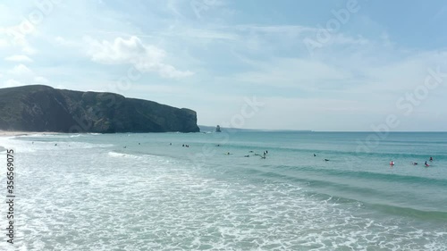 Surfers at Praia da Arrifana enjoying to lear how to surf on the little waves close to the beach