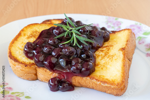 Homemade French toasts with blueberries on a plate.