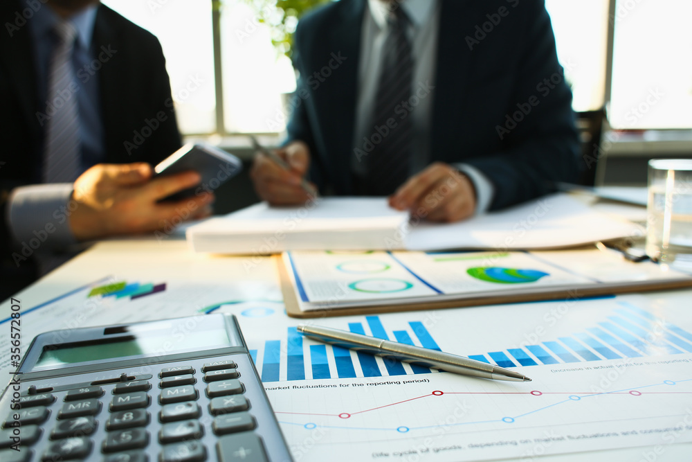 Financial statistics documents ball pen infographics at office table closeup. Internal Revenue Service inspector sum check investigation exchange market earnings savings loan and credit concept Financial statistics documents ball pen infographics at office table closeup. Internal Revenue Service inspector sum check investigation exchange market earnings savings loan and credit concept