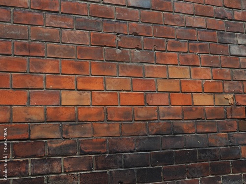 Old weathered orange and brown coloured brick wall in Budapest downtown, Hungary