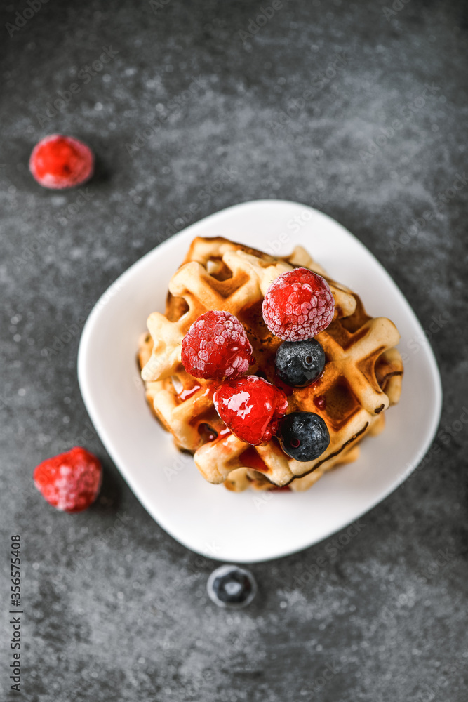 Belgian or french waffles for breakfast. Beautiful serve waffer cake with berries Belgian or french waffles for breakfast. Beautiful serve waffer cake with berries