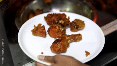 Deep frying chicken in an India Kadhai at a street food market in Zakir Nagar, Delhi photo