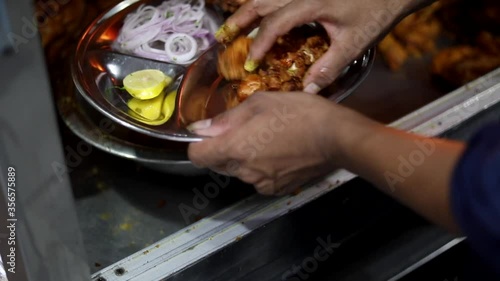 Serving fried chicken with onions, lemon and green mint chutney at Gulbahar Chicken Fry, Zakir Nagar photo