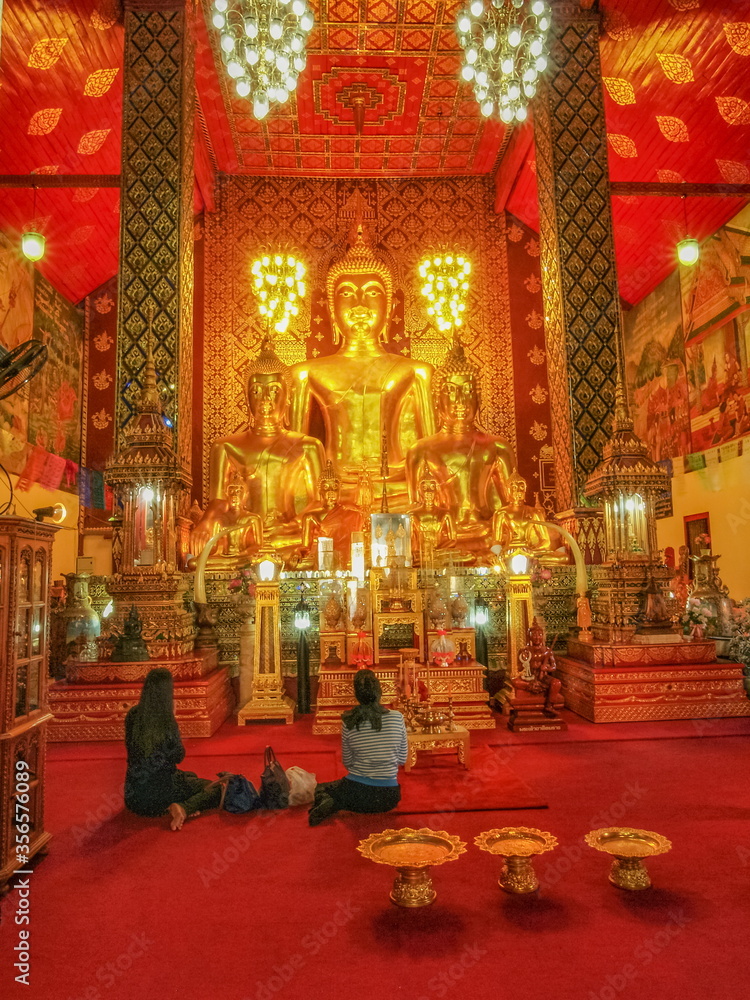 view of Giant Golden Buddha Statue in buddhist temple, Lanna Style Art 13th. Century. Wat Phra That Haripunchai Woramahawihan, Lamphun Province, northern of Thailand.