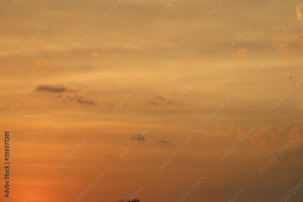 sky at the time of sunset with yellow and orange coloured clouds
