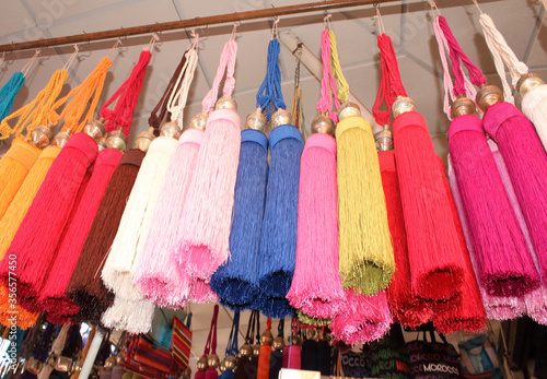 Colorful Moroccan cord curtain ties hanging in the market in Morocco.