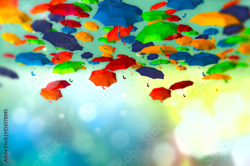 Colored umbrellas in the sky on bokeh background photo