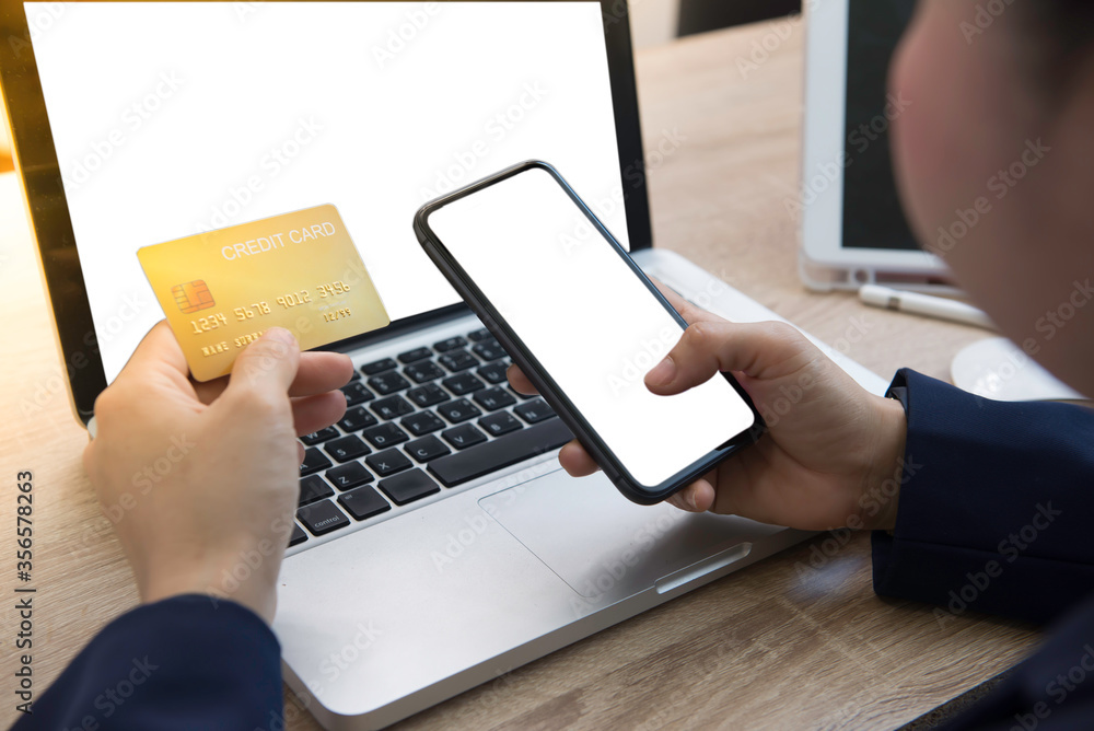 woman hands holding a smartphone and mock up credit card. woman hands holding a smartphone and mock up credit card.