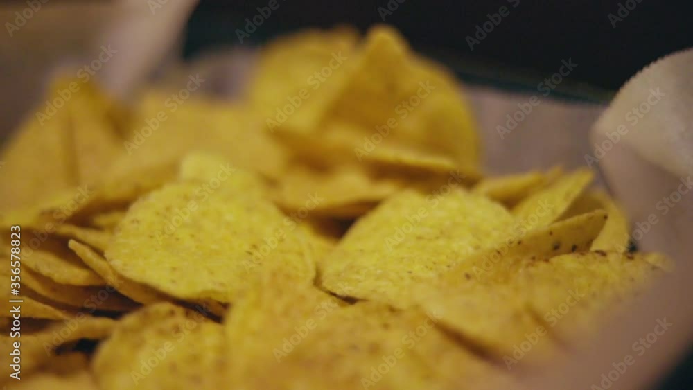 Nachos laying in a pan camera sliding Nachos laying in a pan camera sliding
