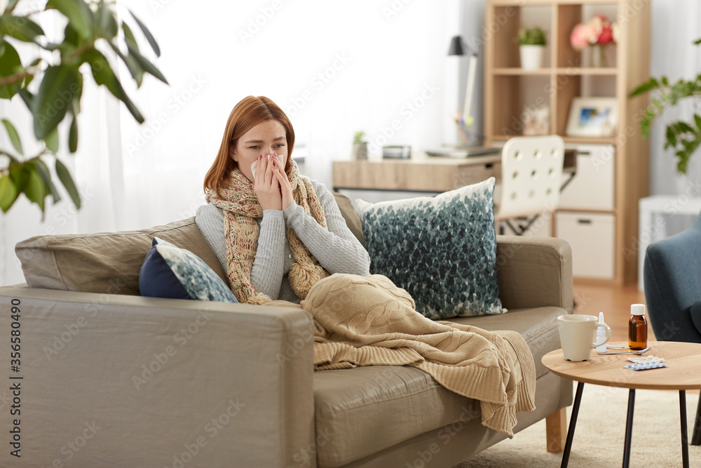 healthcare, cold, allergy and people concept - sick woman blowing her runny nose in paper tissue at home healthcare, cold, allergy and people concept - sick woman blowing her runny nose in paper tissue at home